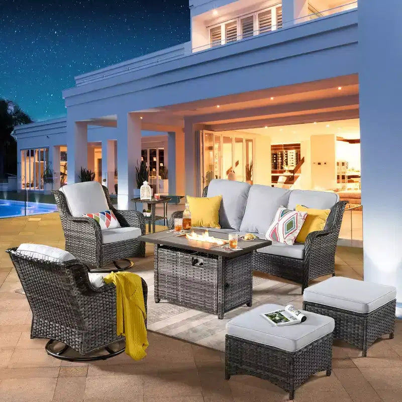 Ensemble de conversation de 7 meubles de patio Ovios Orlando en osier marron avec foyer rectangulaire, fauteuils pivotants et coussins