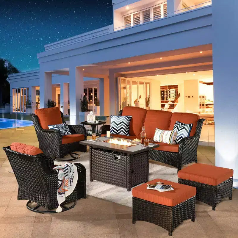 Ensemble de conversation de 7 meubles de patio Ovios Orlando en osier marron avec foyer rectangulaire, fauteuils pivotants et coussins